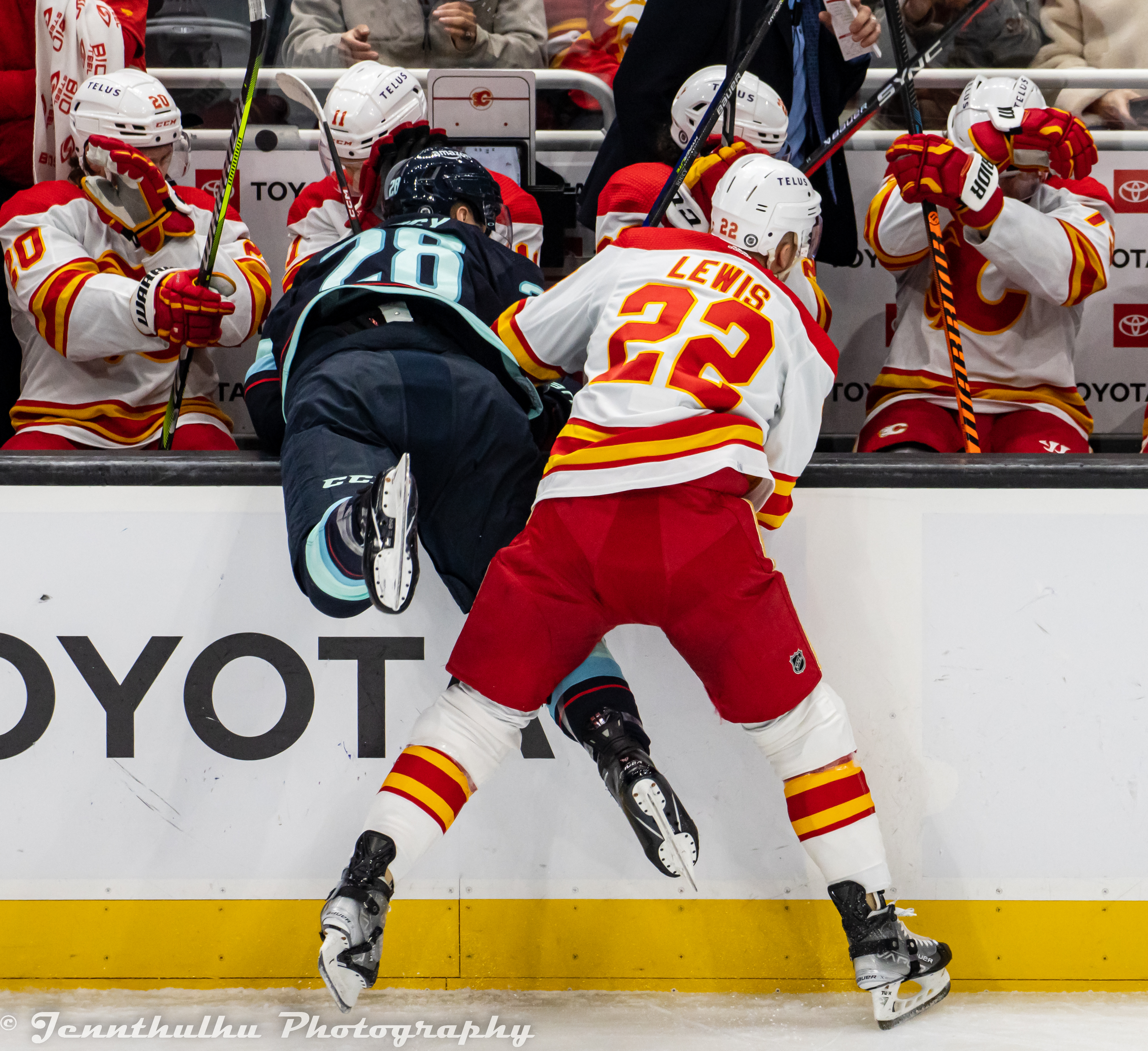 Trevor Lewis checking Carson Soucy near the Flames bench, 2023