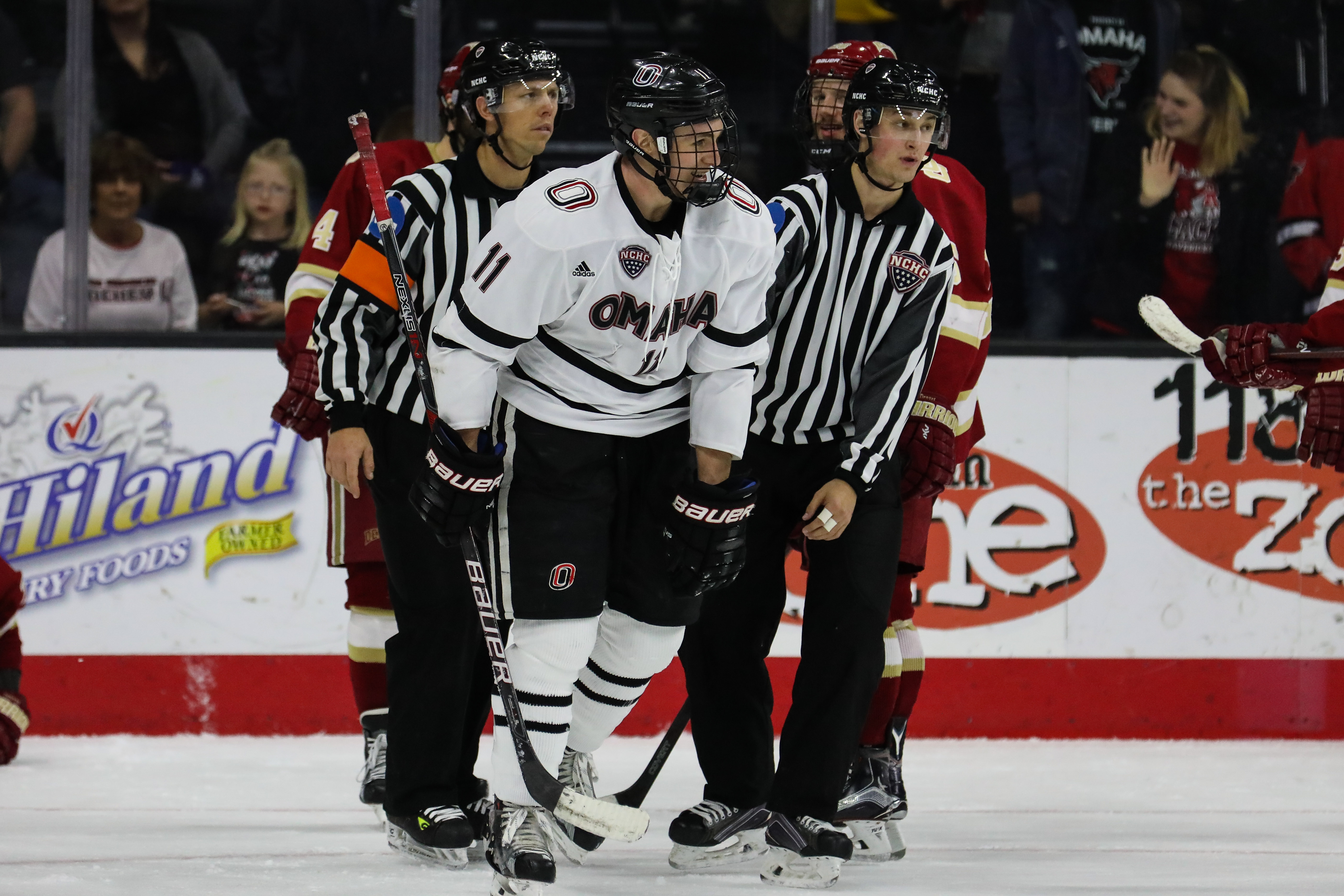 Mason Morelli being escorted to the penalty box for roughing