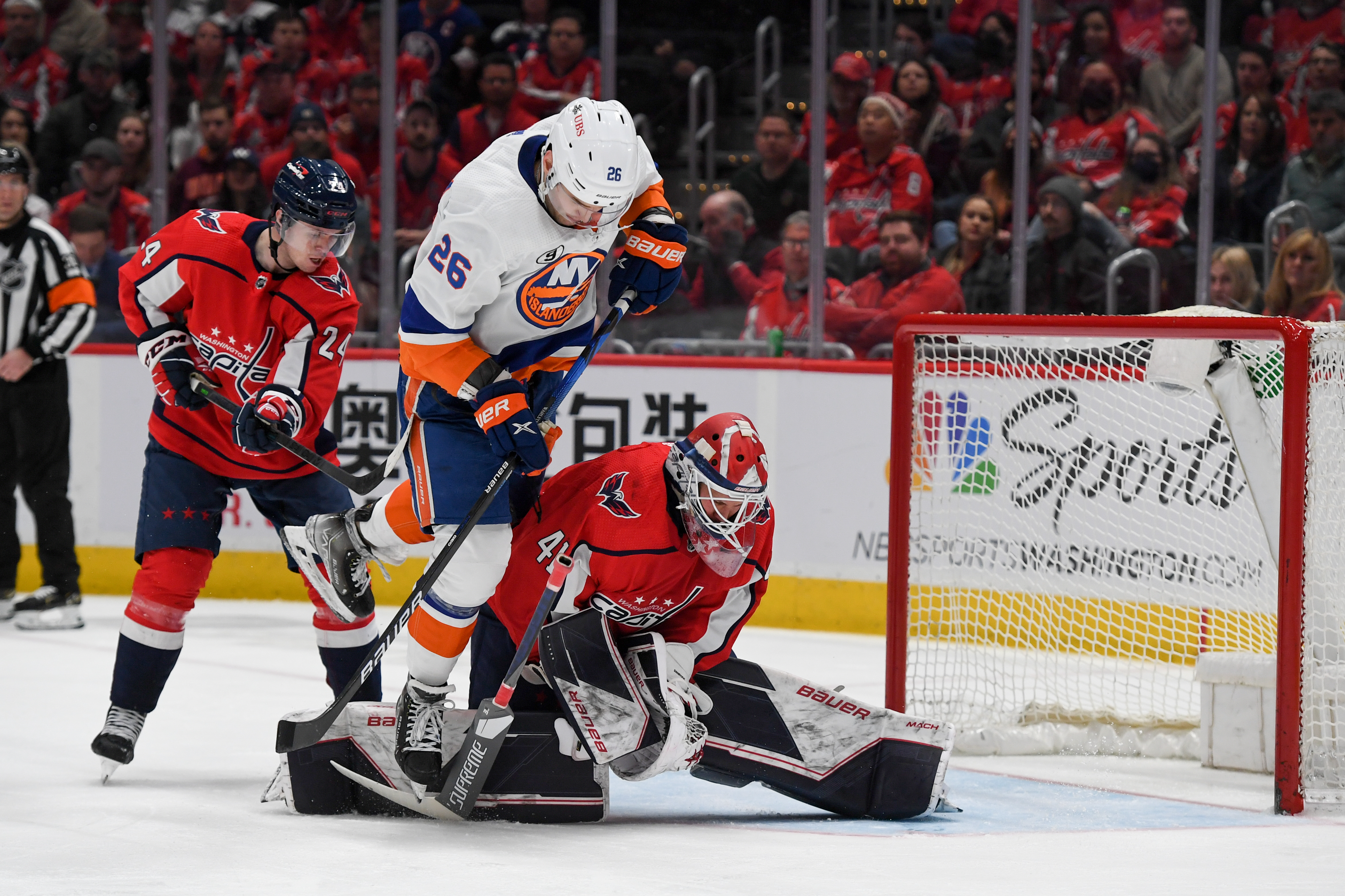 Oliver Wahlstrom battling in front of the net as Vitek Vanecek makes a save