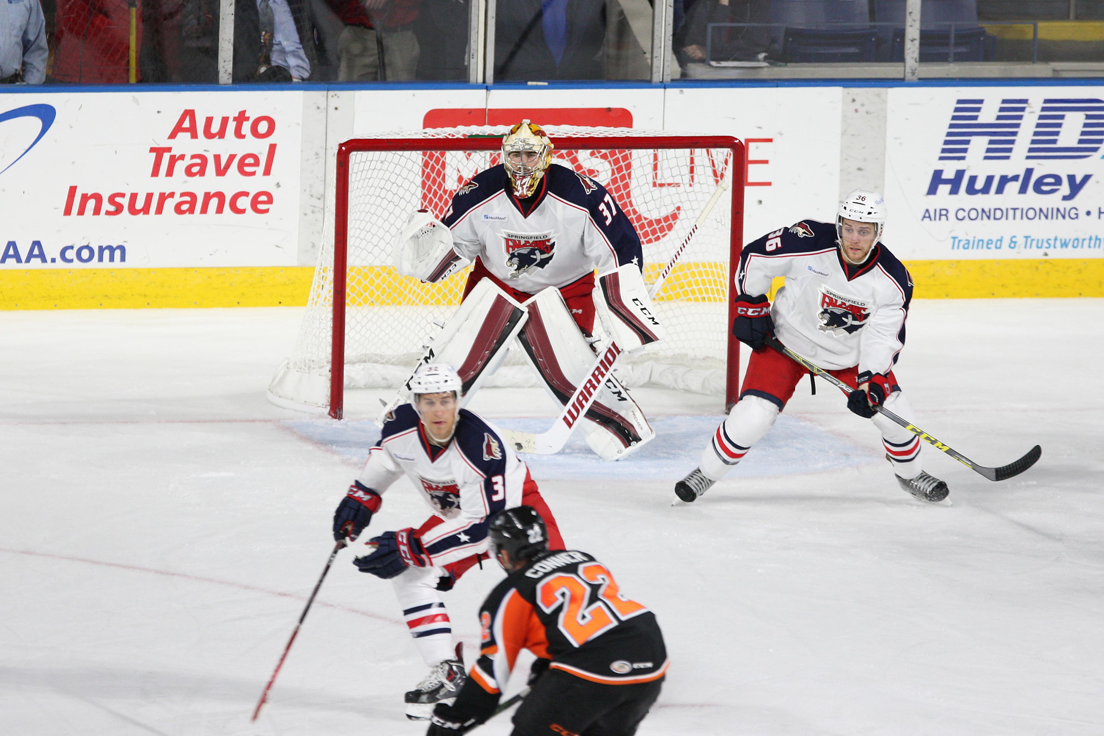 Louis Domingue between Tyler Gaudet and Dakota Mermis of the Springfield Falcons