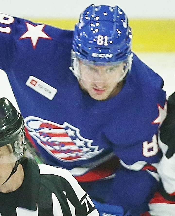 Brett Murray in Rochester Americans uniform skating with the puck