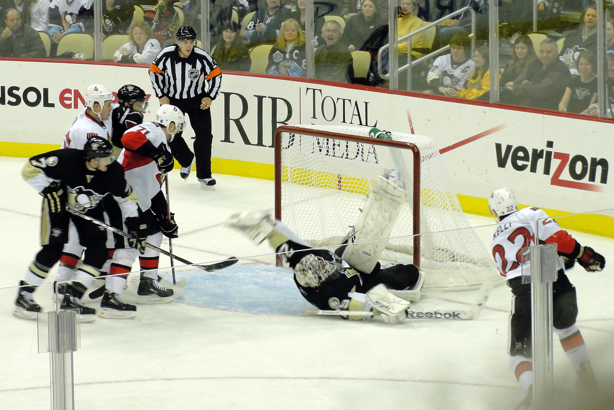Marc‑André Fleury making a highlight save in blue and yellow