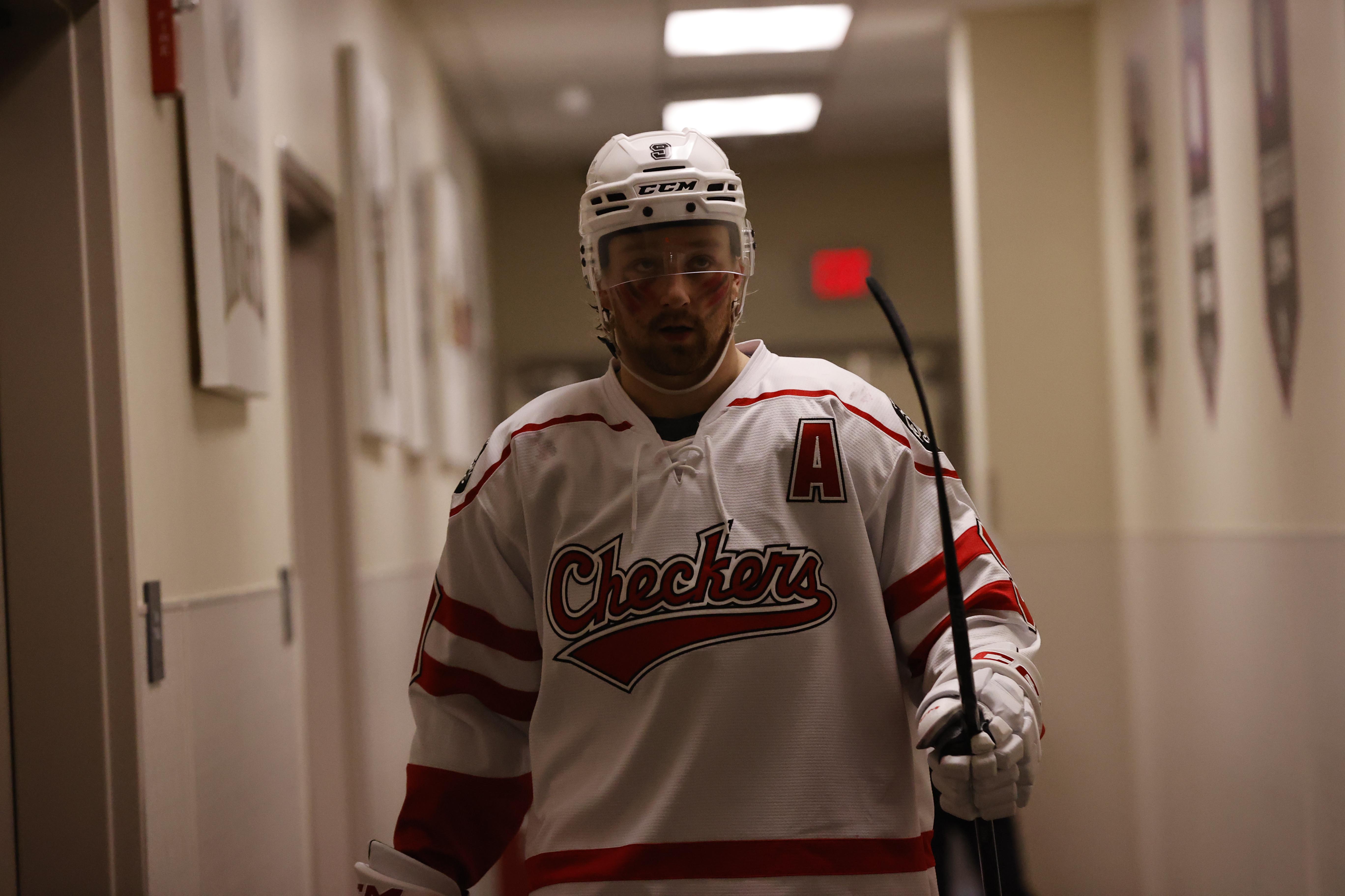 Rasmus Asplund walking in an arena hallway