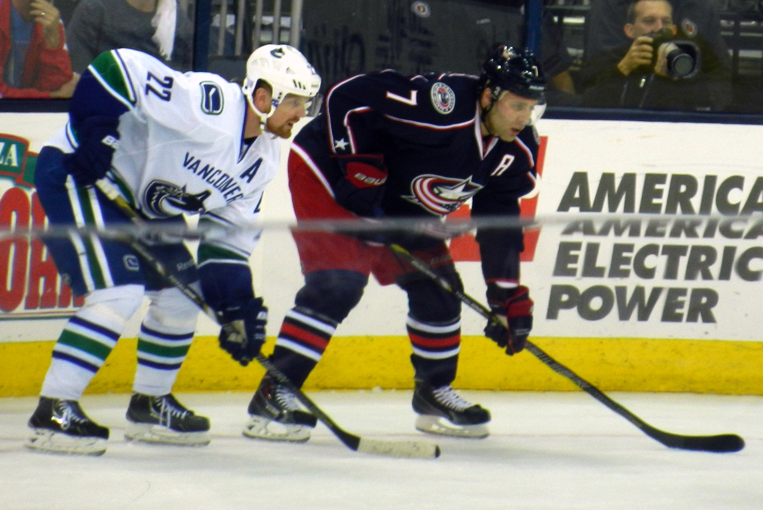 Jack Johnson (right) facing Daniel Sedin, 2013